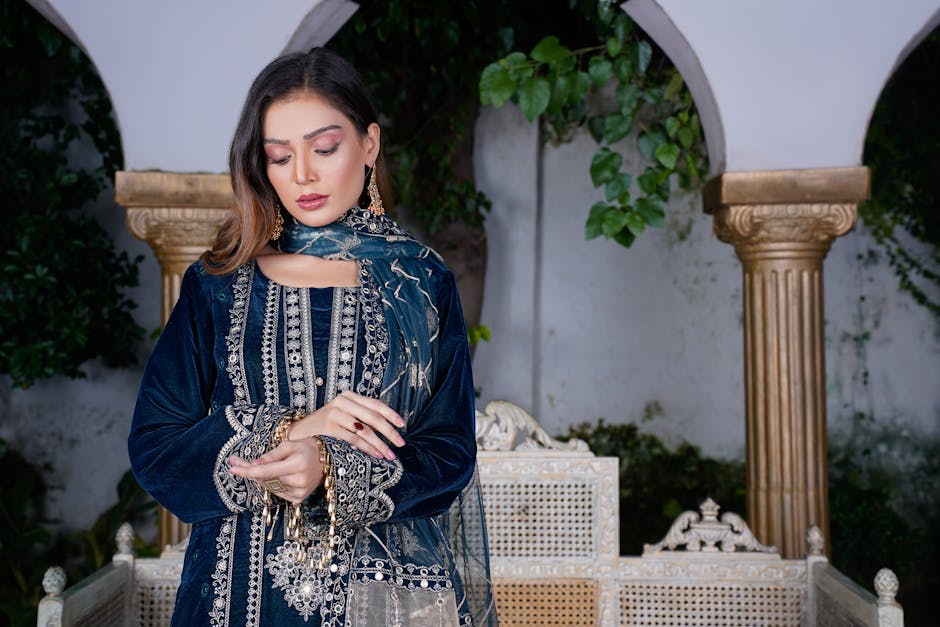 A beautiful woman in traditional Pakistani attire poses elegantly in Lahore, showcasing intricate embroidery.